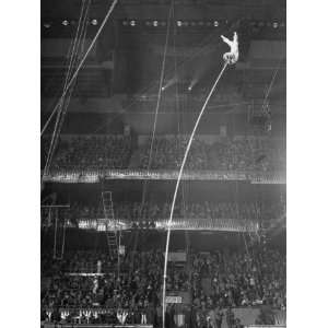Circus Performer Alberty at Top End of 45 Ft. Pole Doing a Handstand 