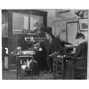  Man,woman in an unidentified office,c1903,telephone,fan 