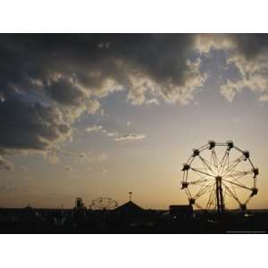  A Ferris Wheel is Silhouetted against the Evening Sky 