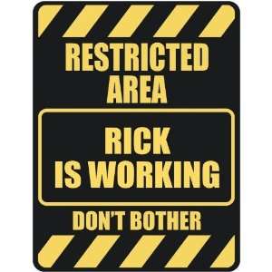   RESTRICTED AREA RICK IS WORKING  PARKING SIGN