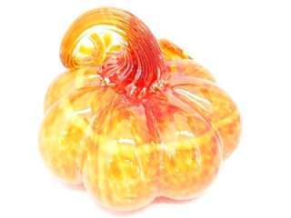   colored pumpkin has a stem that swirls around like a ribbon for a