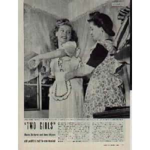 Gloria DeHaven is helped with her apron by her mother. Mrs. DeHaven 