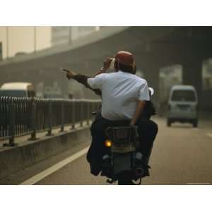  Two Men on a Motor Bike on a Smoggy Roadway in Guangzhou 